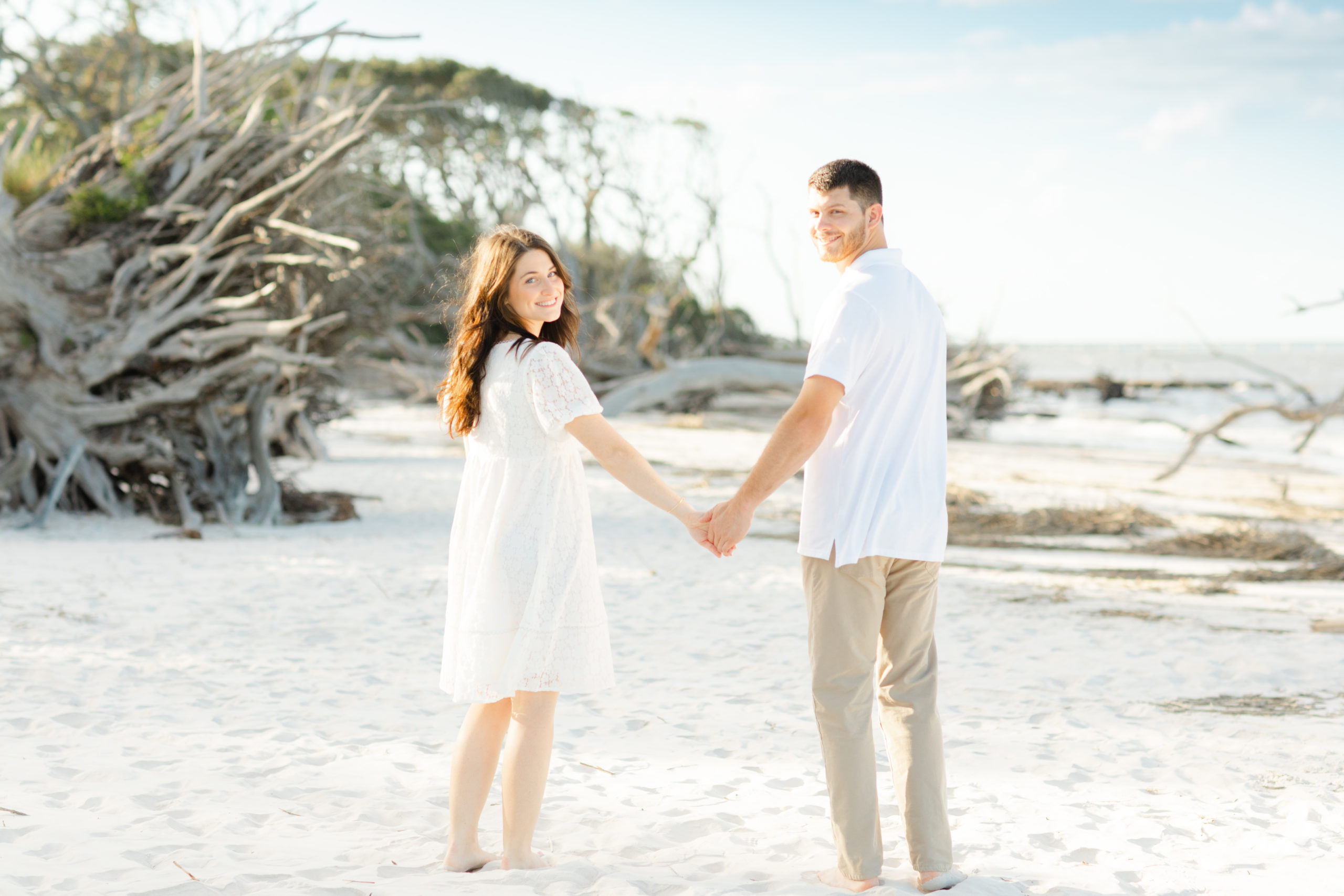 Couple walking and holding hands during their engagement session at Big Talbot Island in Jacksonville Florida